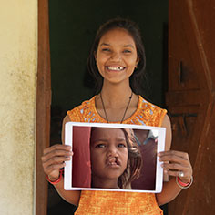 A girl holding a photo of herself. Read about Gifts of Appreciated Securities A girl holding a photo of herself. Read about Gifts of Appreciated Securities