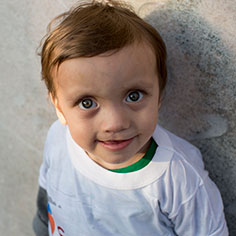 A boy smiling. Read about Donating Stocks and Securities A boy smiling. Read about Donating Stocks and Securities