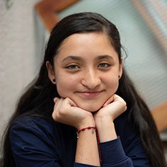 A girl smiling. Read about Gifts of Real Estate