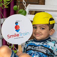 Photo of a boy holding a sign. Link to Life Stage Gift Planner Under Age 60 Situations.