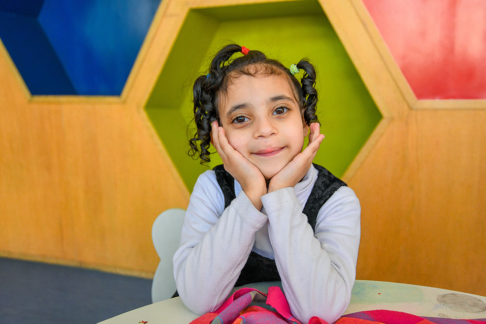A girl smiling.