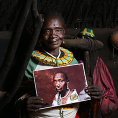 An older woman holding her photo. Links to What to Give